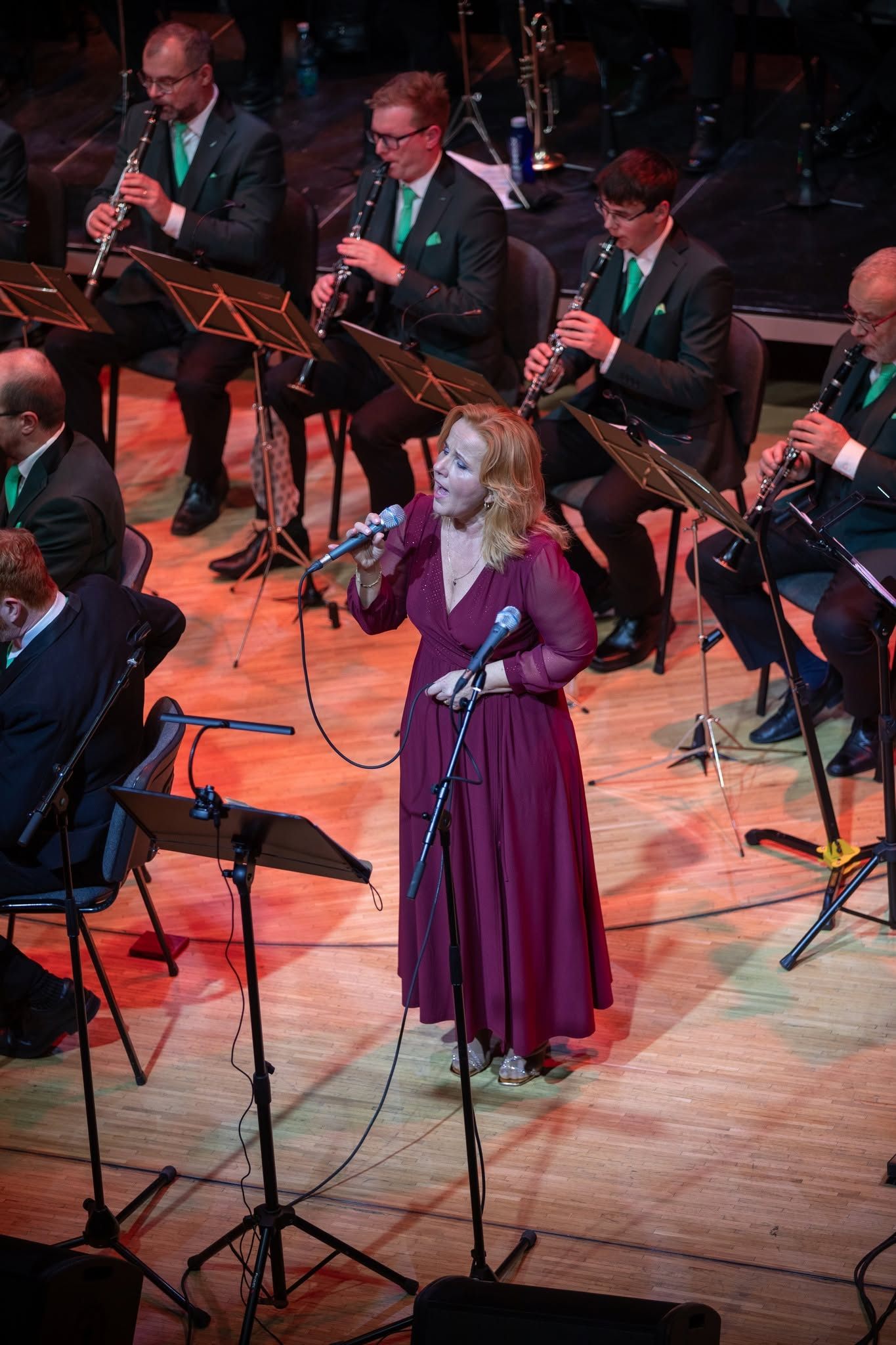 Markéta Amerighi singing solo, wine-red dress